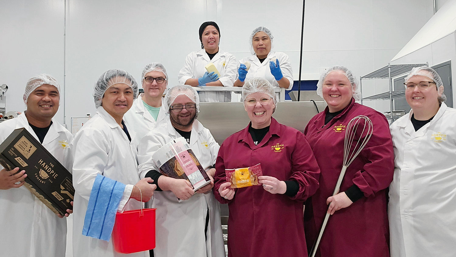 Sarah Bennetto O’Brien proudly standing at the Handpie production facility with her team