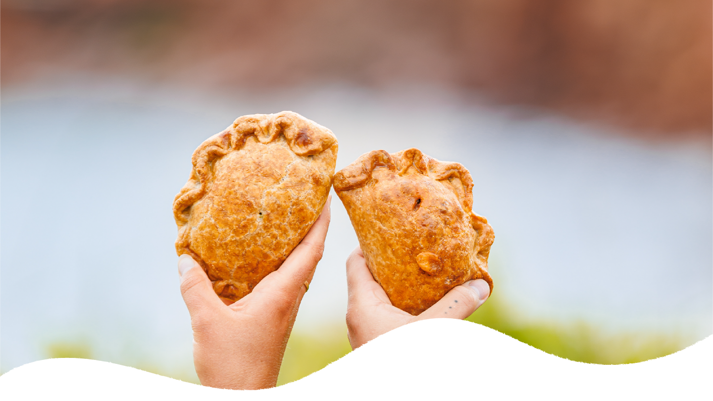 Two handpies cheers together in celebration of convenient comfort food in PEI