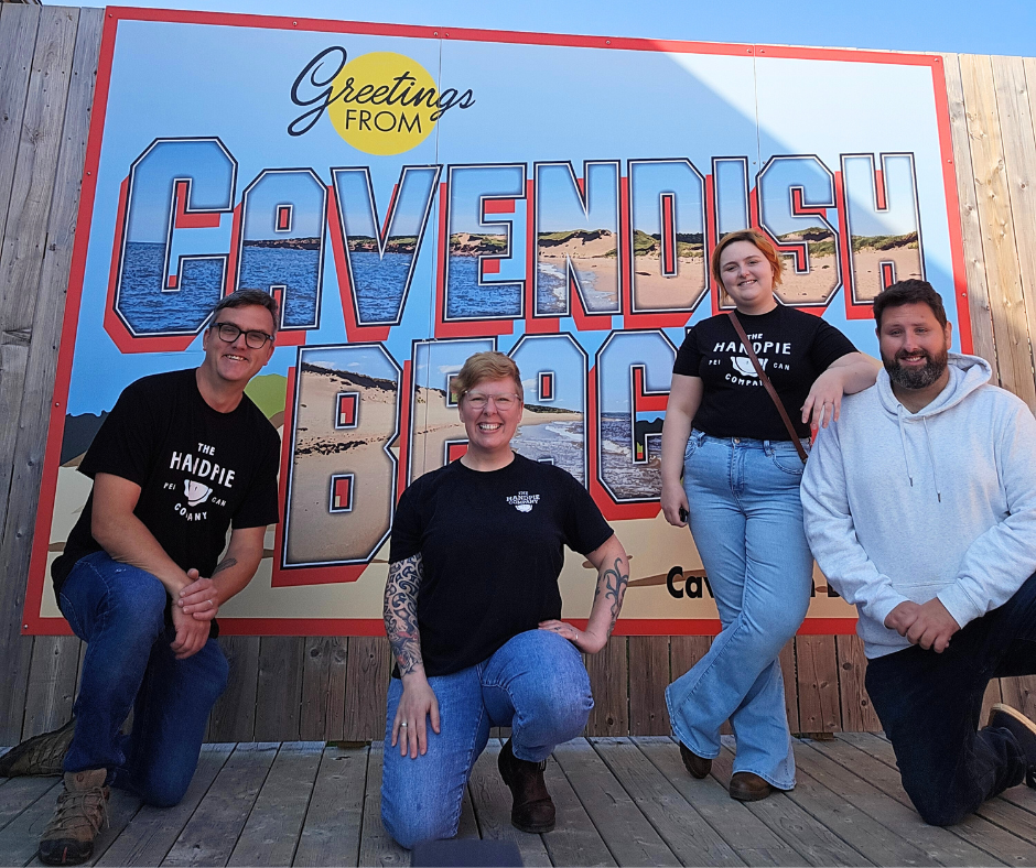 The Handpie Company team members standing in front of the Cavendish Beach sign to celebrate their Cavendish beach food location