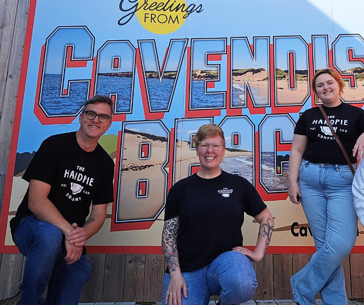 The Handpie Company team members standing in front of the Cavendish Beach sign to celebrate their Cavendish beach food location